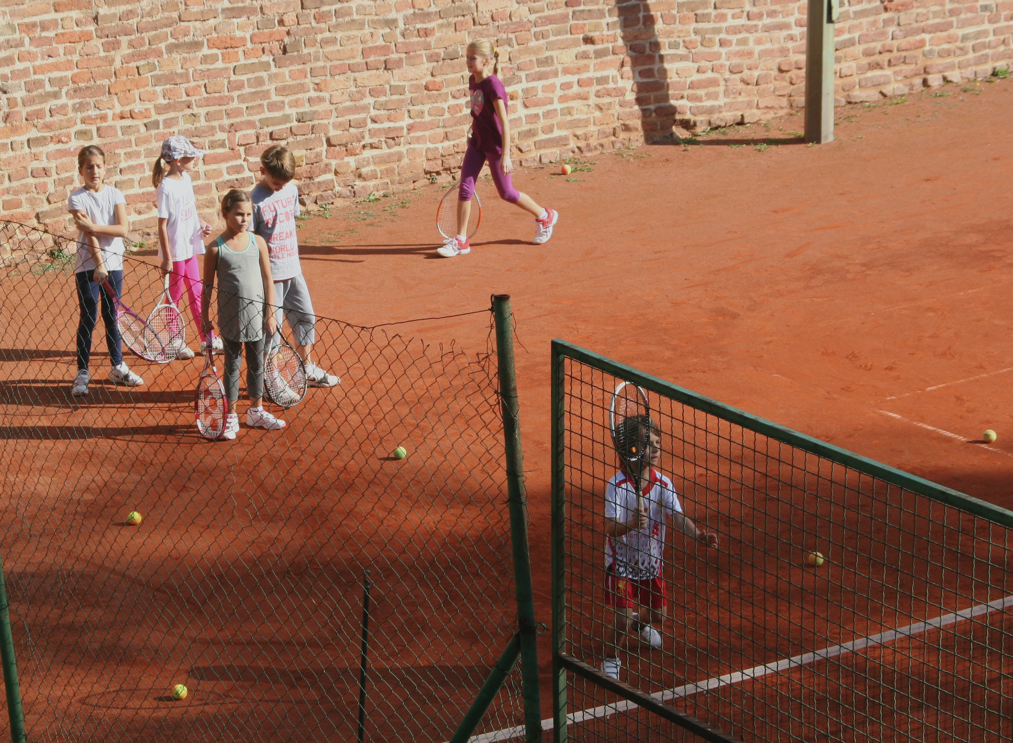 A child playing badminton. Yard games children.